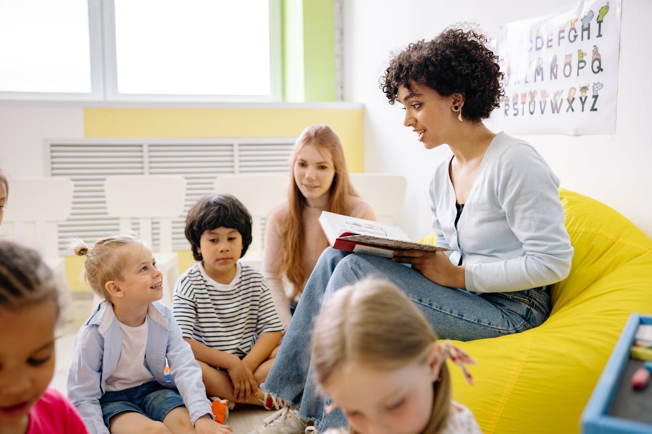Educator reading aloud to engaged young learners